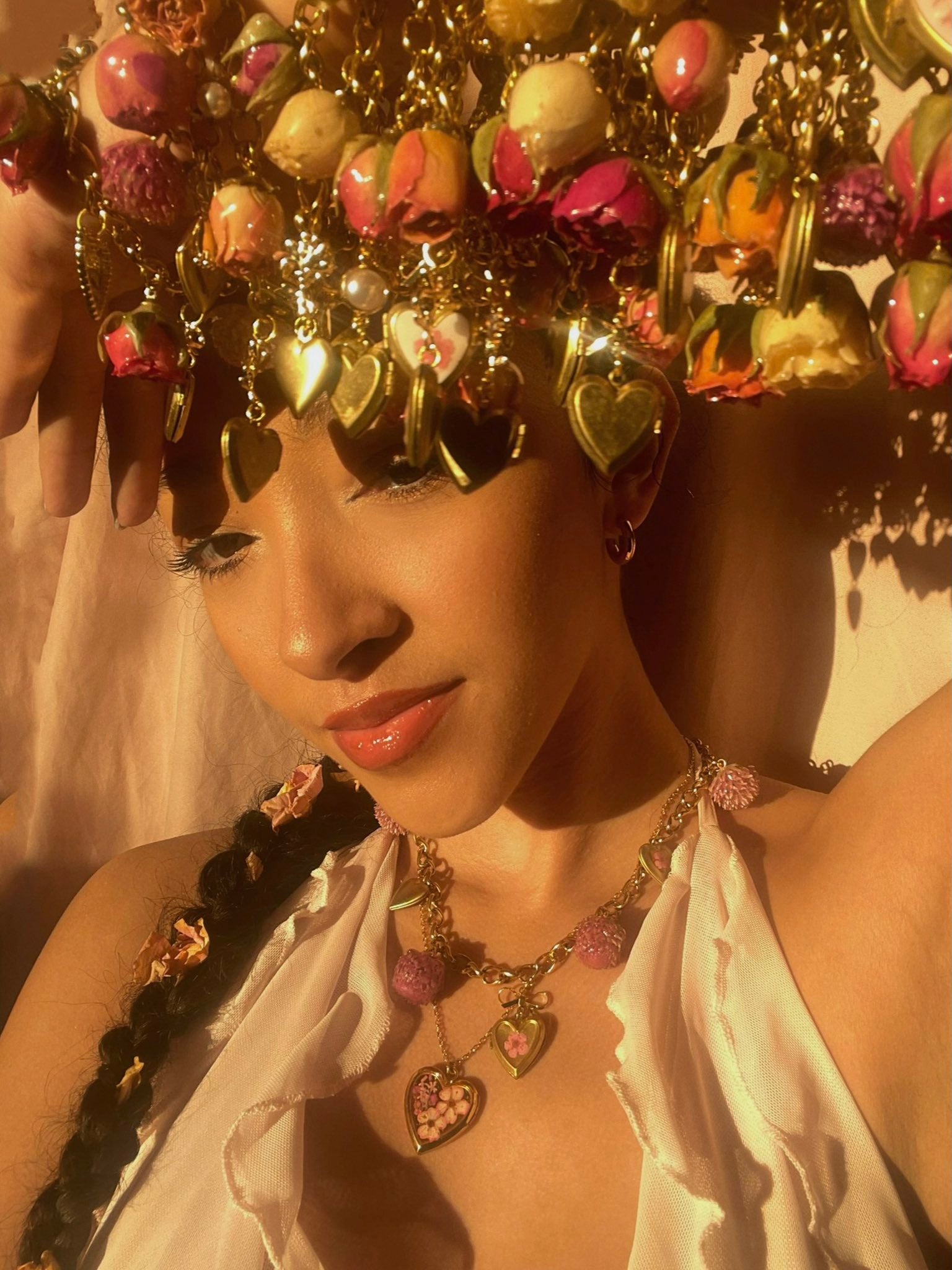 Mikaela Greene, founder of Greene Is Gold, wearing her flower charm necklaces and heart lockets